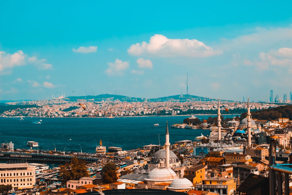 Explore Istanbul's iconic skyline with its mix of historic architecture and vibrant watercraft activity on the Bosphorus.